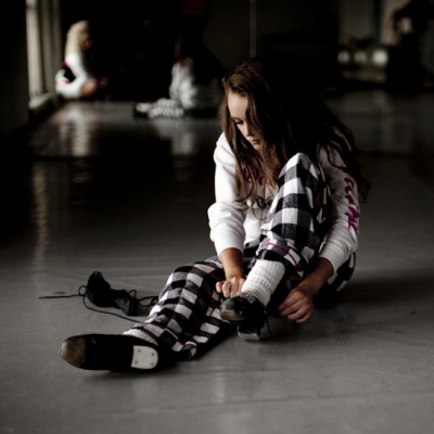 Young girl putting on her Irish dancing shoes